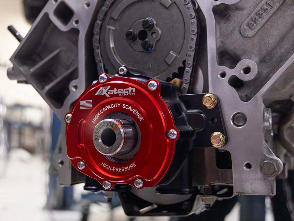Katech TrackFlow LS9 billet dry-sump oil pump (red, KAT-A7974) installed on a bare LS engine block